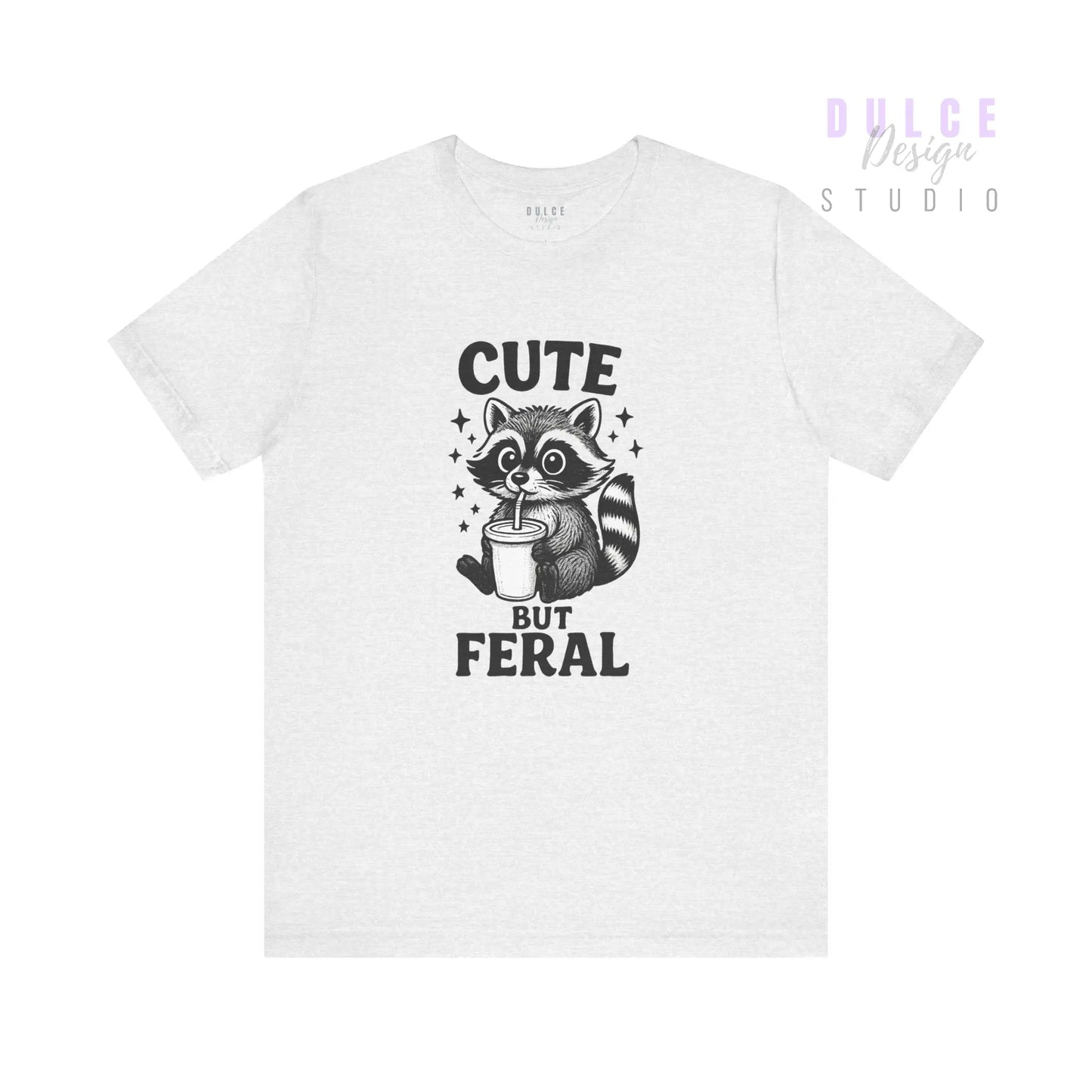 White t-shirt with a raccoon graphic and text 'Cute But Feral' on a white background