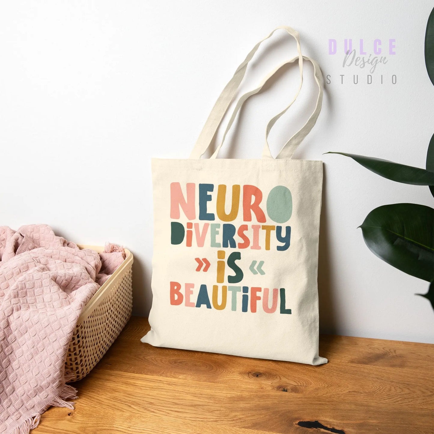 Natural Canvas tote bag with colorful text reading ‘Neurodiversity Is Beautiful’ in playful font styles