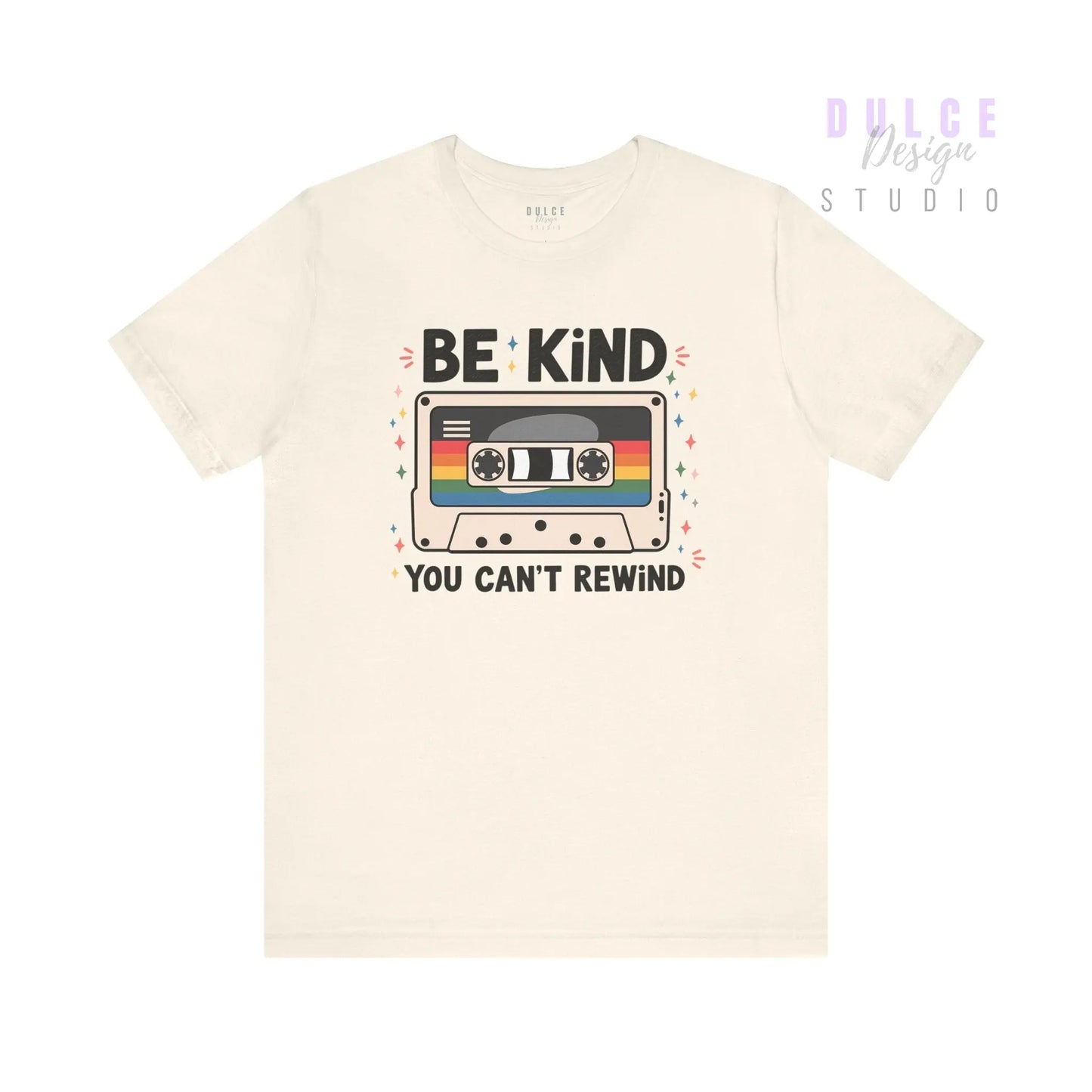 Beige t-shirt with a cassette tape graphic and 'Be Kind You Can't Rewind' text on a white background
