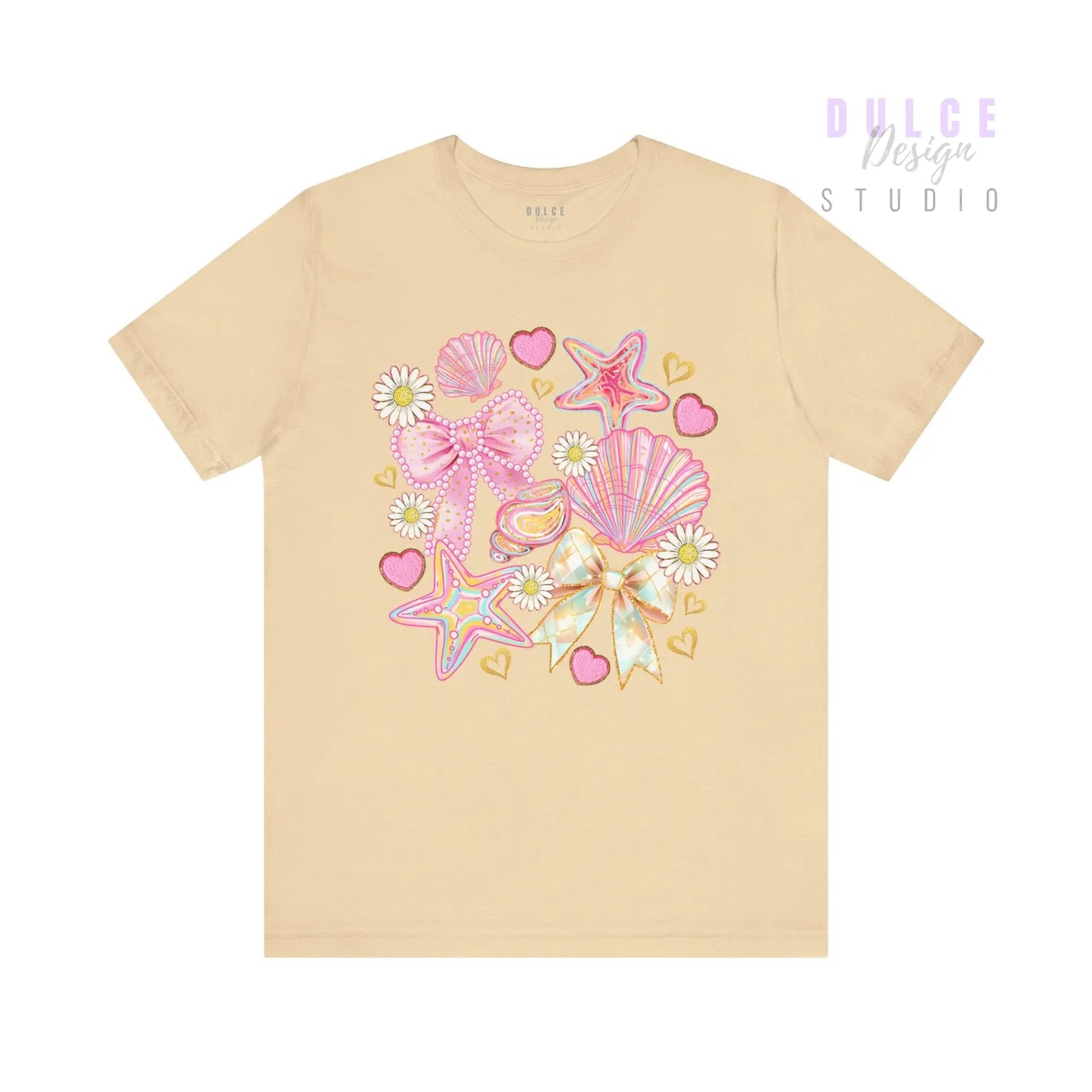 Beige t-shirt with colorful bow and shell design on a white background