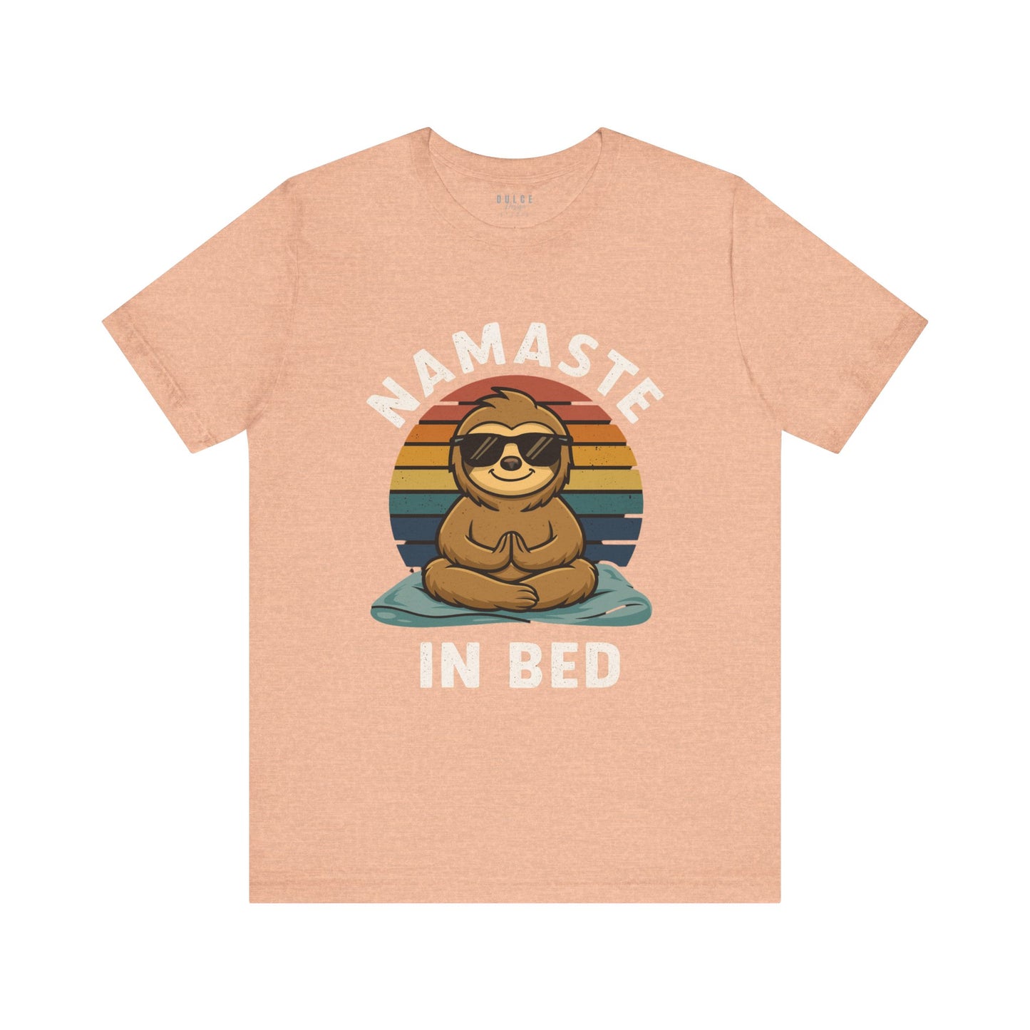 Peach t-shirt with a sloth graphic and 'Namaste in Bed' text on a white background