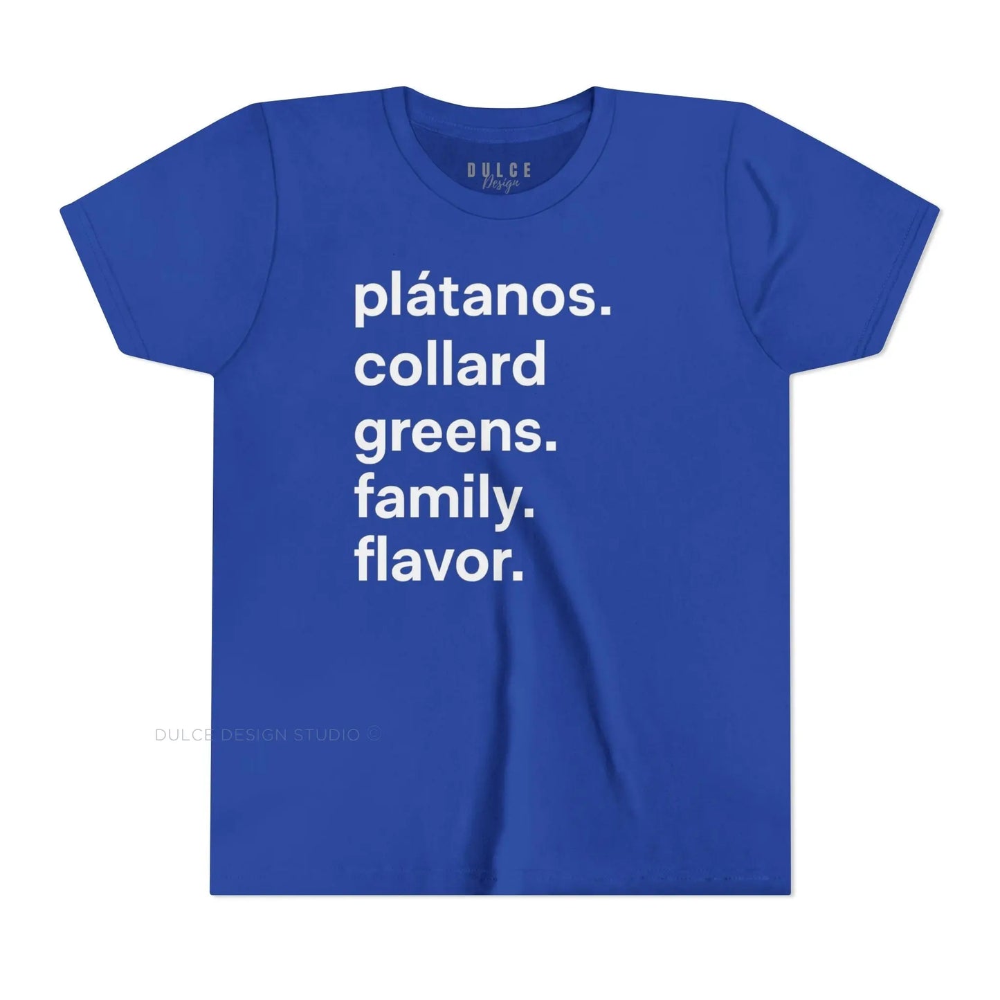 A child wearing a black crew neck t-shirt with the text 'plátanos. collard greens. family. flavor.' printed in white.