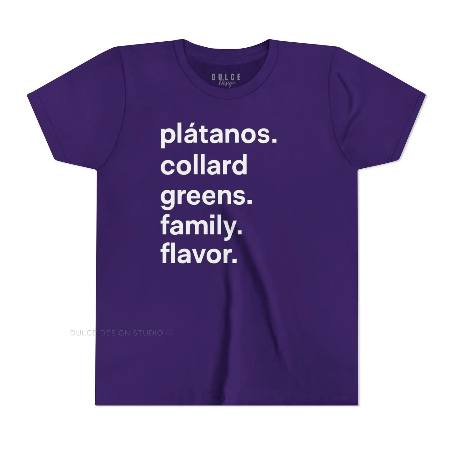 A child wearing a black crew neck t-shirt with the text 'plátanos. collard greens. family. flavor.' printed in white.