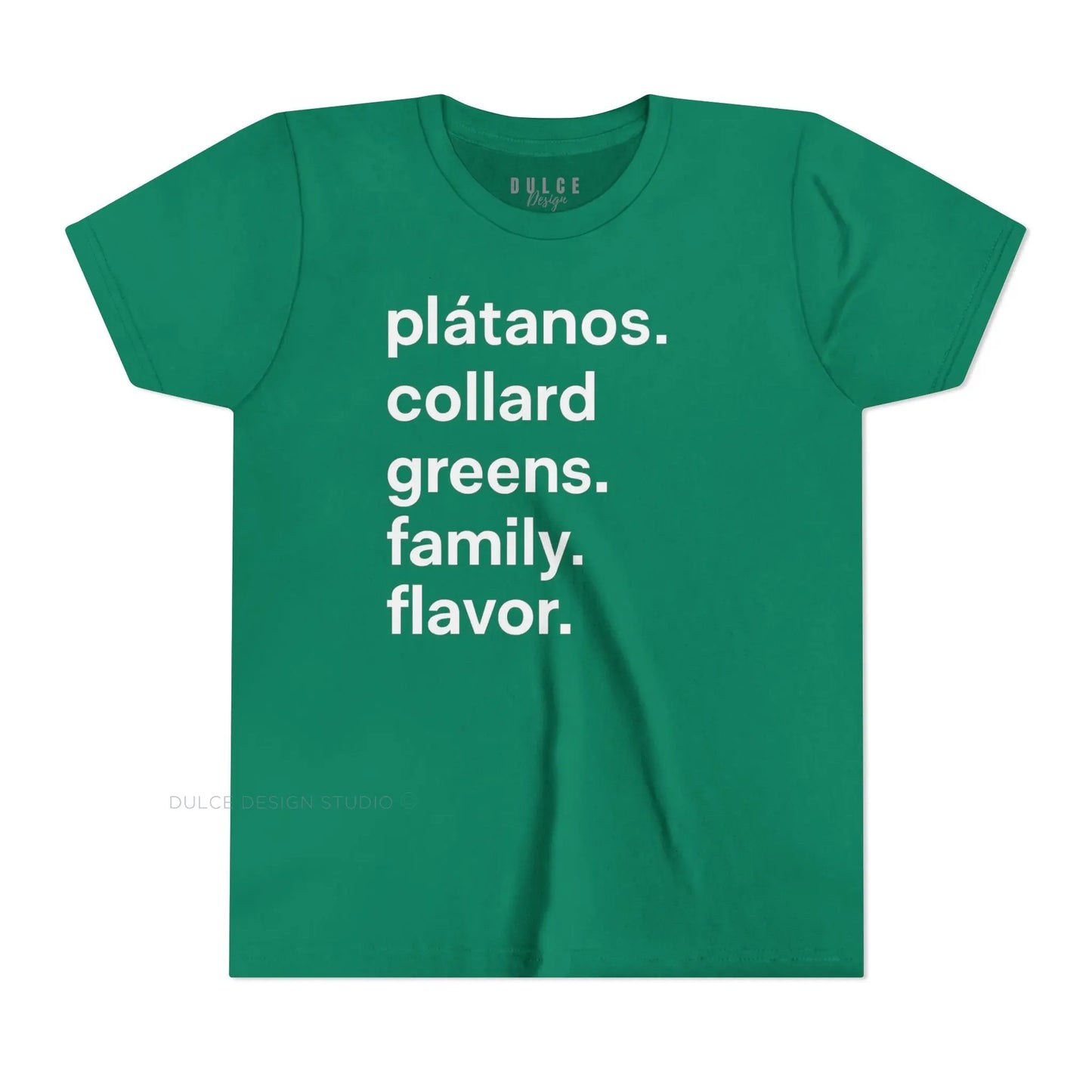 A child wearing a black crew neck t-shirt with the text 'plátanos. collard greens. family. flavor.' printed in white.