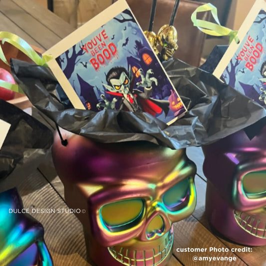 Close-up of a fun and spooky "You've Been Booed" Dracula digital print placed inside a Halloween-themed gift bucket.