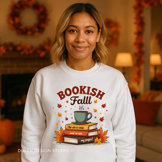 Person wearing a white sweatshirt with 'Bookish Fall' design in a cozy room.