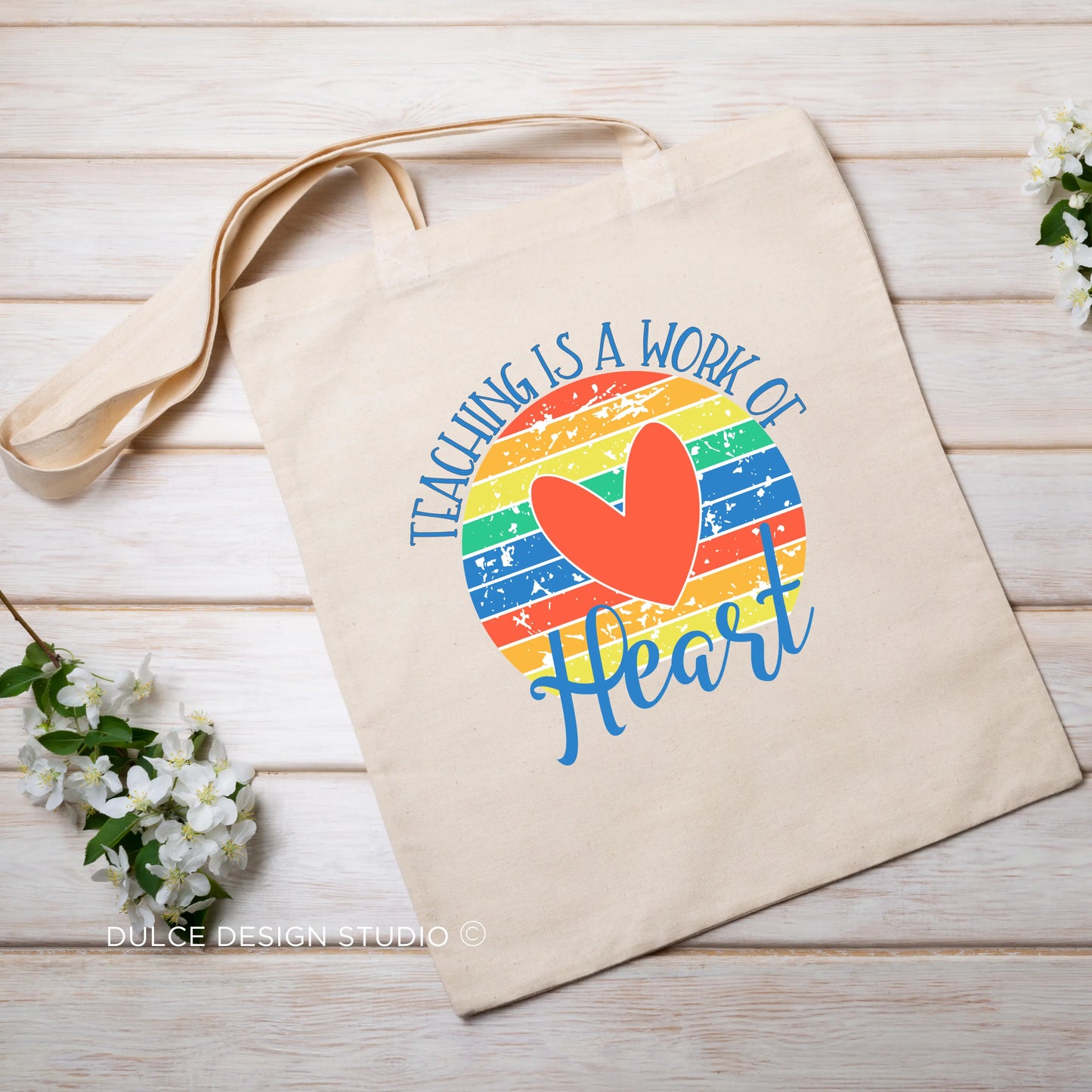 Canvas tote with rainbow heart and “Teaching Is a Work of Heart” text
