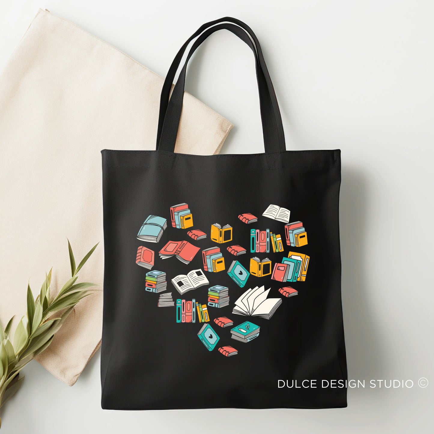 Black tote with books forming a heart and bookish quote design