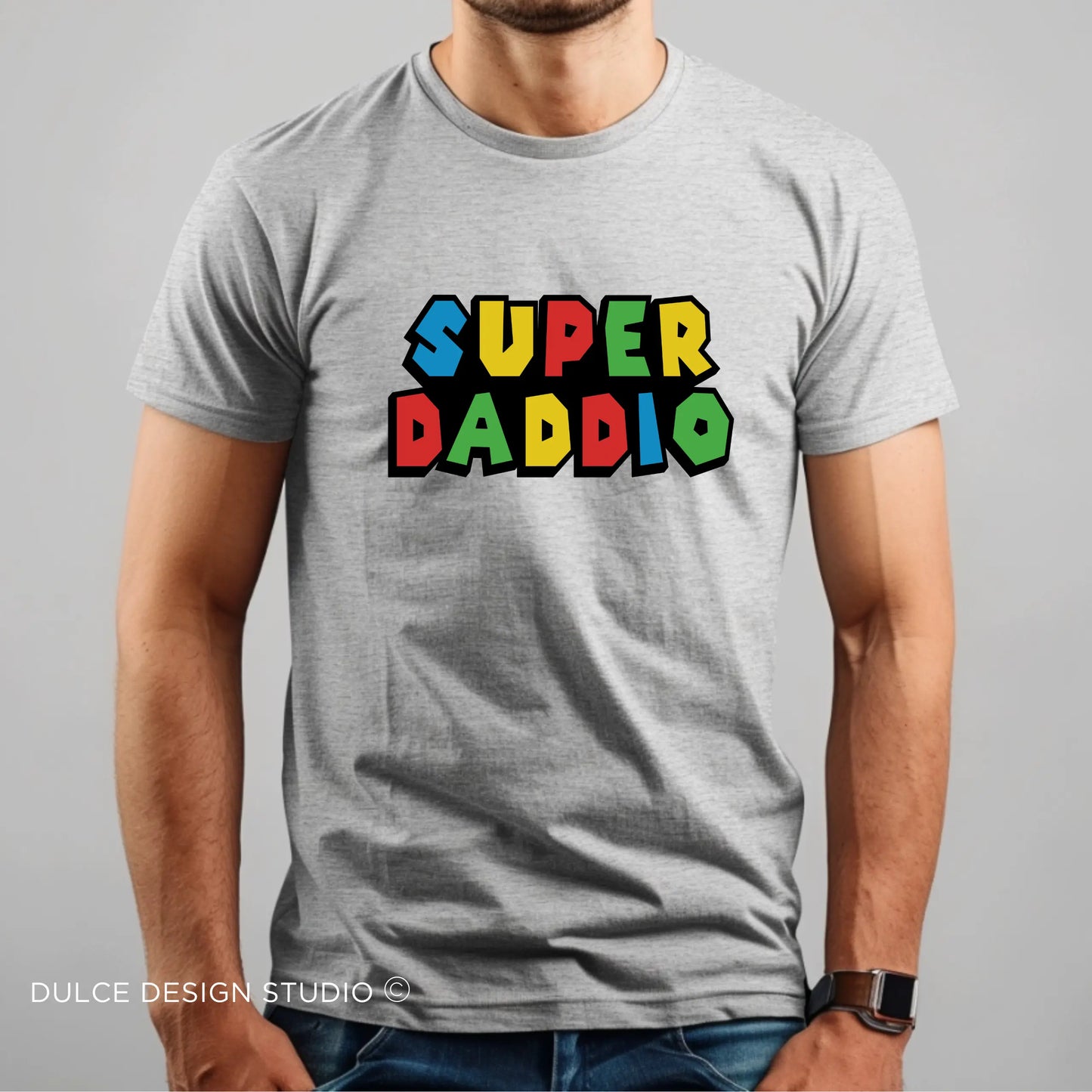 Gray t-shirt with colorful “Super Daddio” text in retro video game style font worn by a man