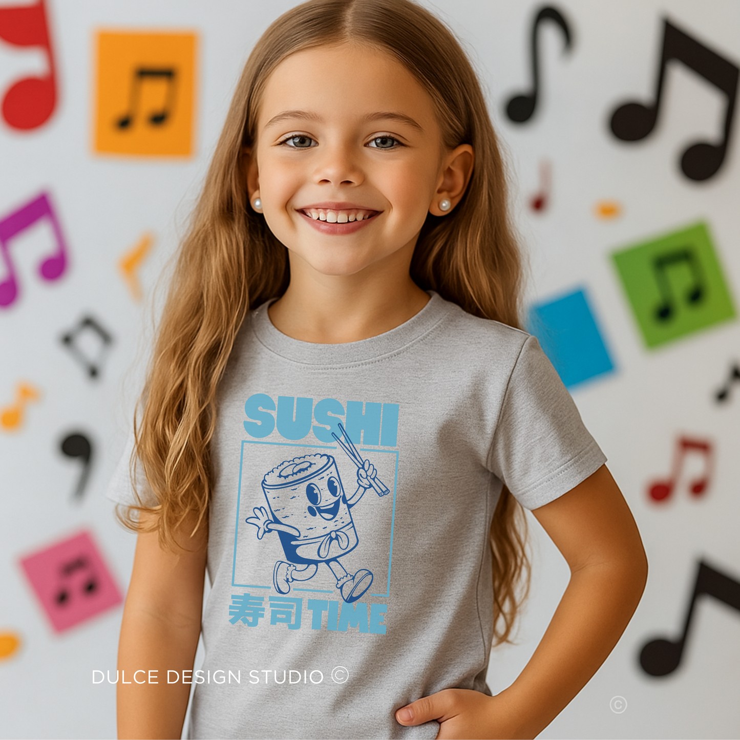 young girl wearing heather grey t-shirt with Retro blue sushi roll character graphic with Japanese text on a kids tee