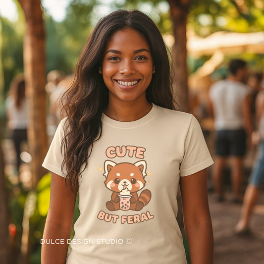 Woman wearing a t-shirt with a red panda design and text, standing outdoors.