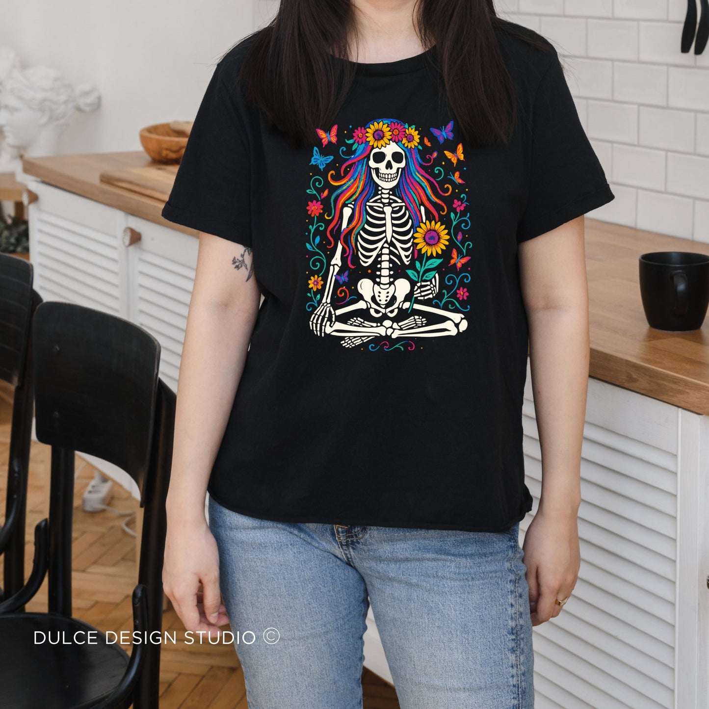 Meditating Skeleton with Rainbow Hair – Floral Boho Goth Tee - Dulce Design Studio