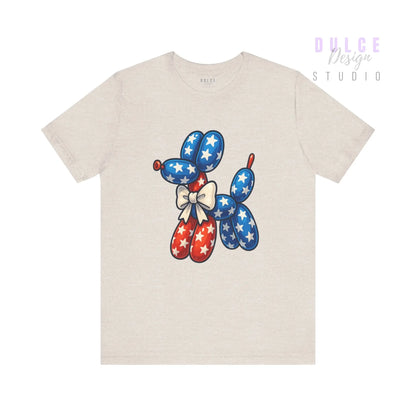 Beige t-shirt with a colorful balloon dog design on a white background