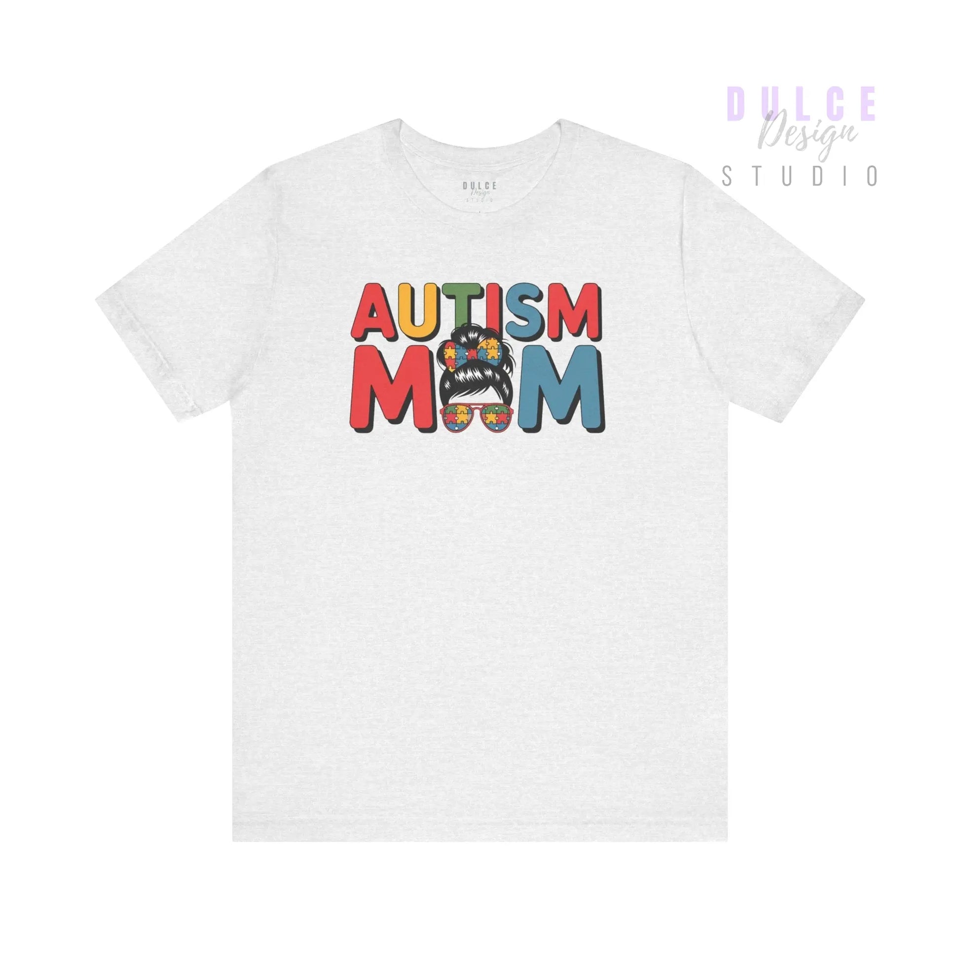 White t-shirt with 'Autism Mom' text and colorful design on a white background