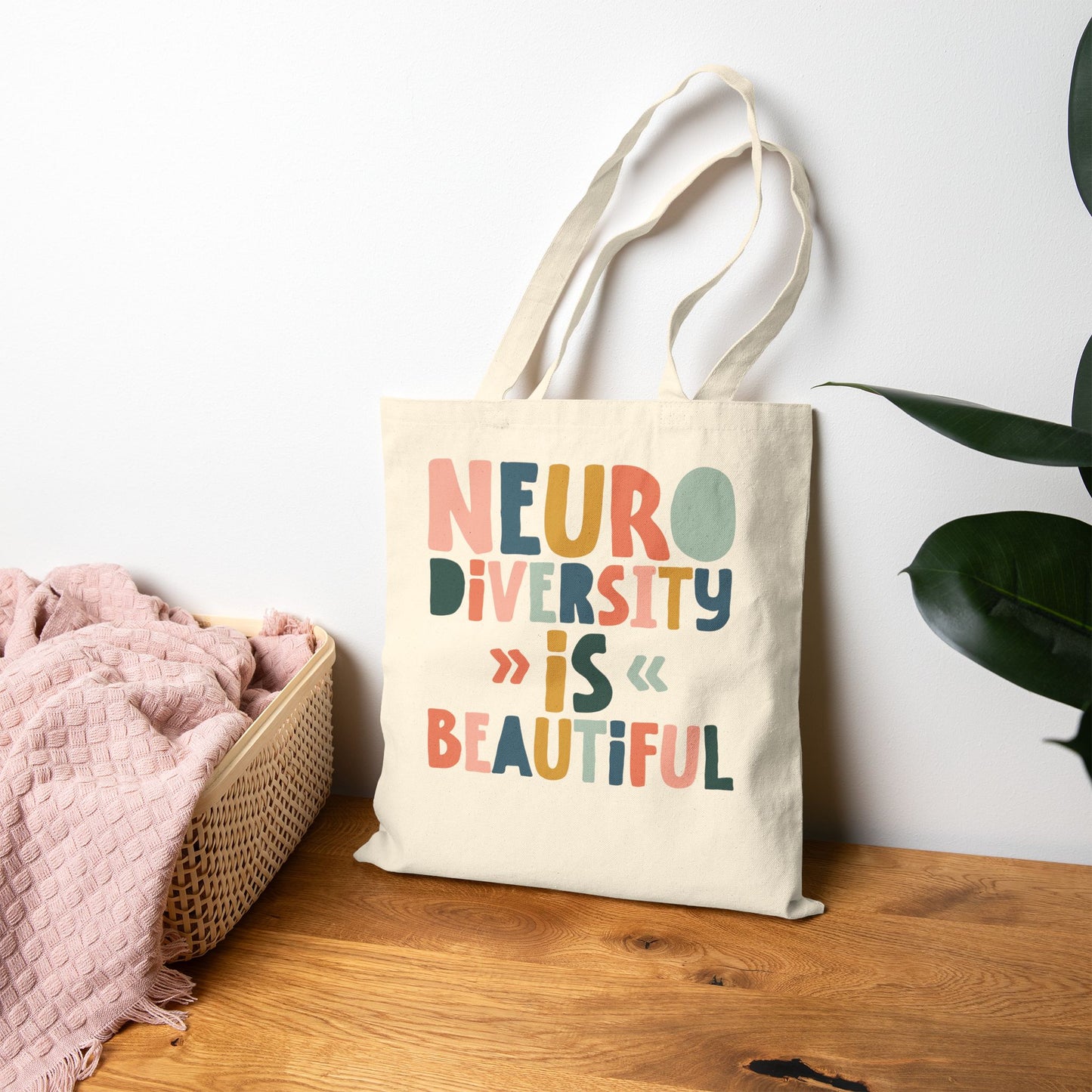 Natural Canvas tote bag with colorful text reading ‘Neurodiversity Is Beautiful’ in playful font styles