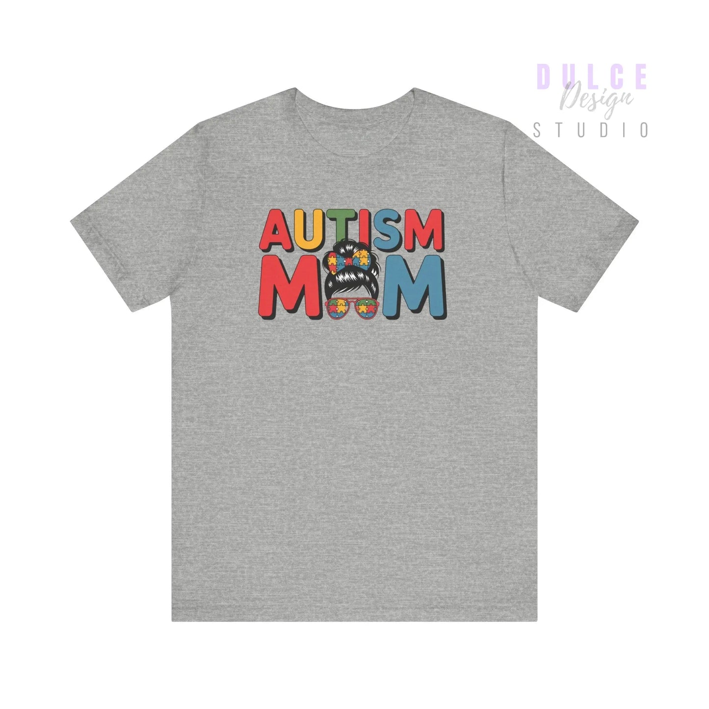 Gray t-shirt with 'Autism Mom' text and colorful design on a white background