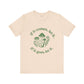 Beige t-shirt with green mushroom graphic and text on a white background