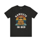 Black t-shirt with a sloth graphic and 'Namaste in Bed' text on a white background