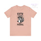 Pink t-shirt with a raccoon graphic and text 'Cute But Feral' on a white background