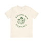Beige t-shirt with green mushroom graphic and text on a white background