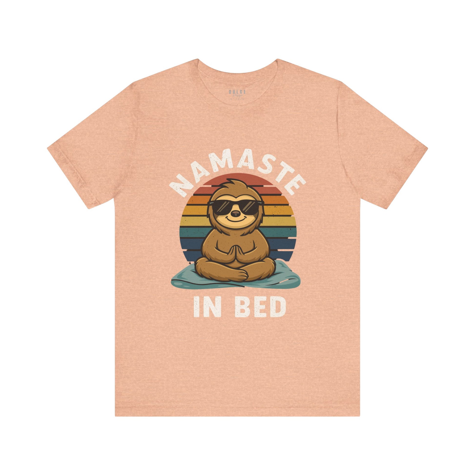 Peach t-shirt with a sloth graphic and 'Namaste in Bed' text on a white background