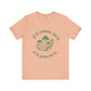 Beige t-shirt with green mushroom graphic and text on a white background