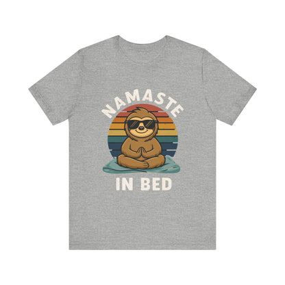 Gray t-shirt with a sloth graphic and 'Namaste in Bed' text on a white background