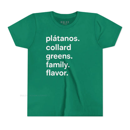 A child wearing a black crew neck t-shirt with the text 'plátanos. collard greens. family. flavor.' printed in white.