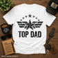 White t-shirt with 'Top Dad' design on a wooden surface with accessories.