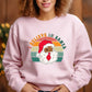 Person wearing a pink sweatshirt with a graphic of a Black Santa Claus and 'Believe in Santa' text.