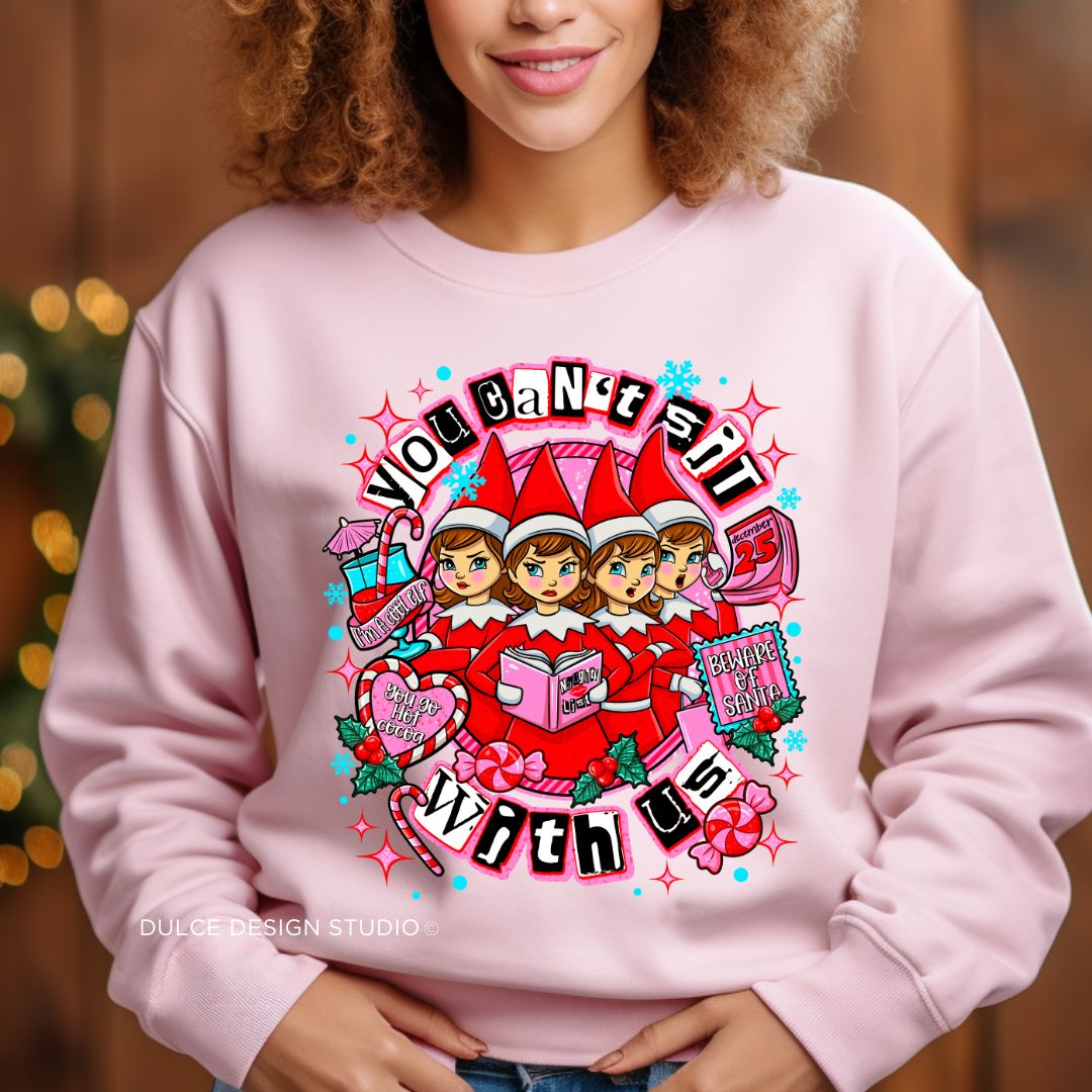 Person wearing a pink sweatshirt with a colorful graphic design and text.
