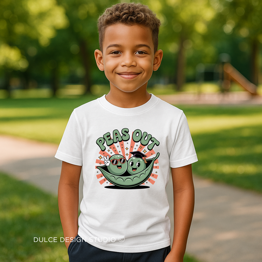 young boy wearing t-shirt with two cartoon peas in a pod, one flashing a peace sign, with retro-style “Peas Out” text on a white shirt
