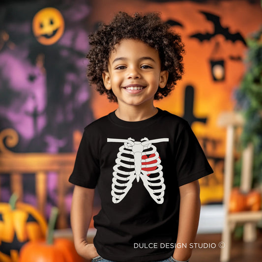 Young child wearing a Skeleton Unisex Youth Tee featuring a ribcage design, perfect for a spooky and stylish Halloween look.