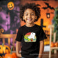 Smiling child wearing a Ghost Dino Unisex Youth T-Shirt with a cute dinosaur in a ghost costume design, perfect for Halloween.