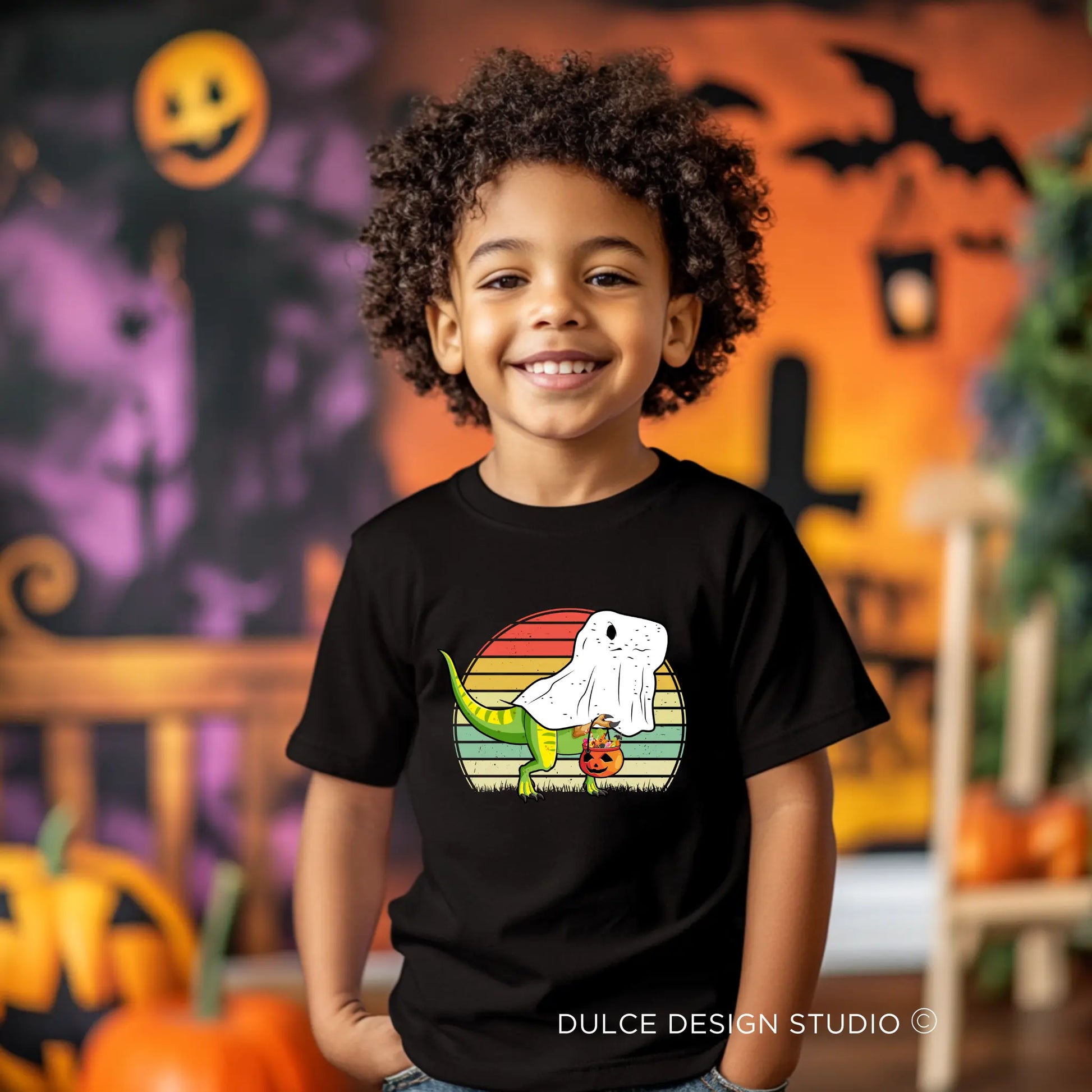 Smiling child wearing a Ghost Dino Unisex Youth T-Shirt with a cute dinosaur in a ghost costume design, perfect for Halloween.