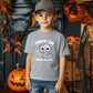Young boy wearing a Trick or Treat A-Lotl Youth Unisex Halloween Tee with a cute axolotl skeleton design, ideal for Halloween celebrations.