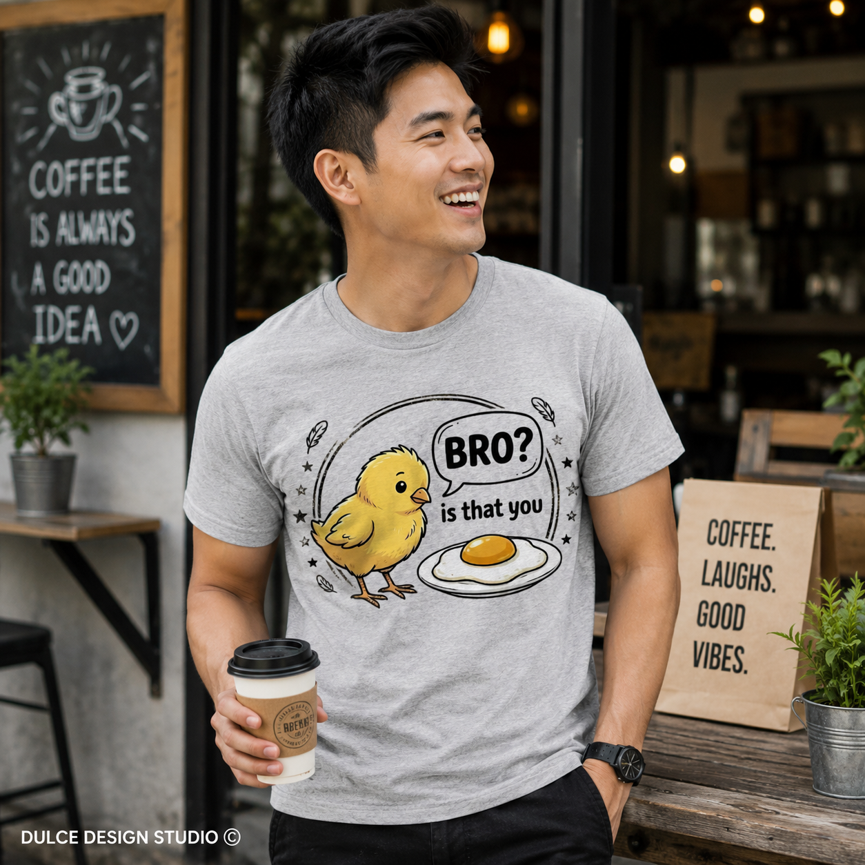 Man wearing a t-shirt with a cartoon design in a coffee shop