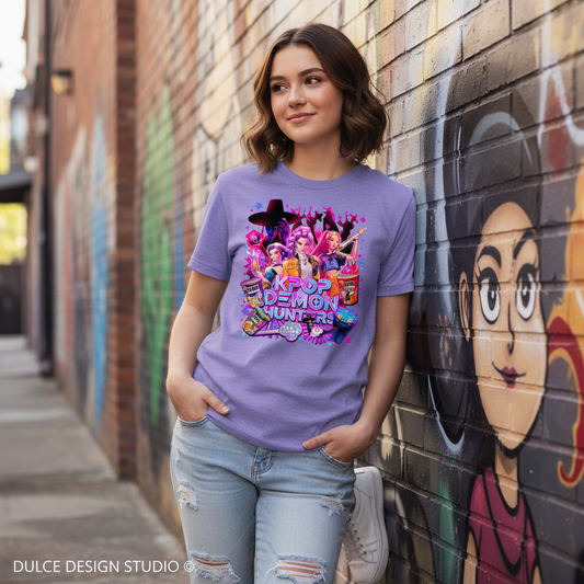 Teen girl wearing a purple t-shirt with a colorful graphic design, standing in front of a brick wall with graffiti.