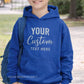 Blue hoodie with 'Your Custom Text Here' text, worn by a person outdoors.