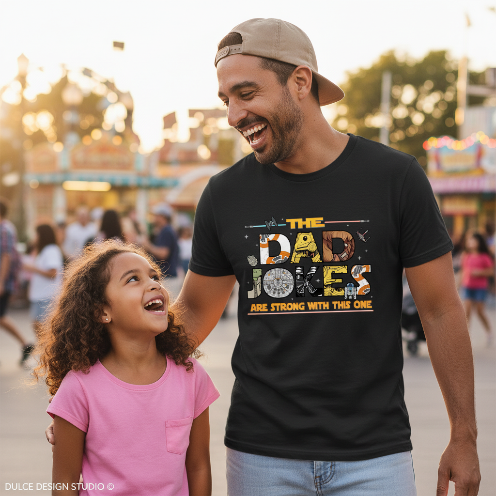 Man and young girl laughing together at an amusement park, with the man wearing a 'Dad Jokes' t-shirt.