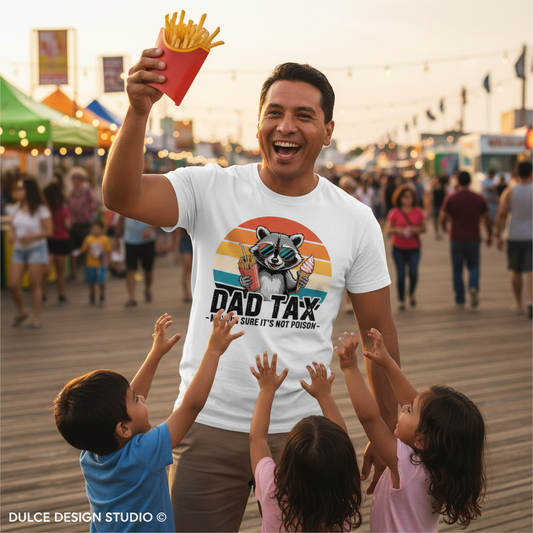 Man in a 'Dad Tax' t-shirt with children on a boardwalk at sunset.