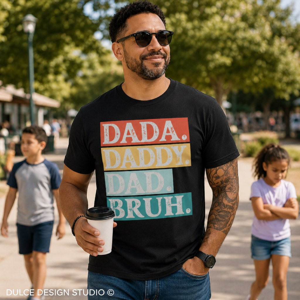 Man wearing a black t-shirt with colorful text in an outdoor setting