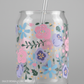 Clear tumbler with floral design and straw on a gray background