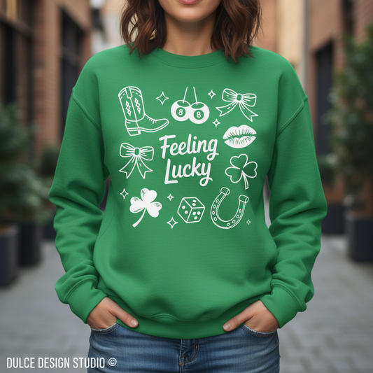Green sweatshirt with white graphics and 'Feeling Lucky' text worn by a person outdoors.