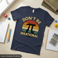 Flat lay of navy t-shirt with Don't Be Irrational Pi design