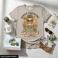 Beige t-shirt with skull design and text, mug, sunglasses, and small items on a light surface.