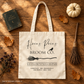Natural canvas Hocus Pocus Broom Co tote flat lay with a book, broom, pumpkin, and autumn leaves