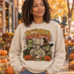 Woman wearing sand October Favorites vintage Halloween monster crewneck at a fall street market