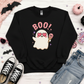 Black crewneck sweatshirt flat lay with drippy pink BOO text, ghost in heart sunglasses holding pink skull ice cream cone