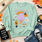 Mint green crewneck sweatshirt with a cute Halloween ice cream design styled in a Halloween flat lay.